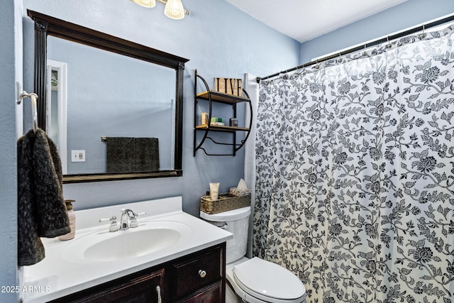 bathroom with a textured wall, a shower with shower curtain, vanity, and toilet