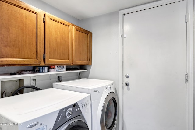 washroom featuring washer and clothes dryer and cabinet space