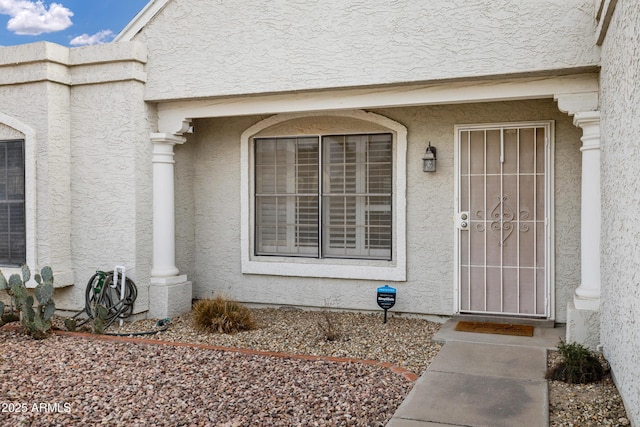 property entrance featuring stucco siding