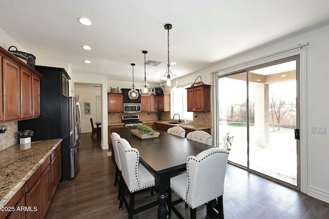 dining space with sink and dark hardwood / wood-style floors