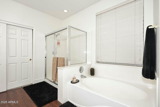 bathroom featuring hardwood / wood-style flooring and separate shower and tub