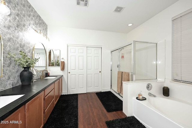 bathroom with vanity, hardwood / wood-style floors, and separate shower and tub