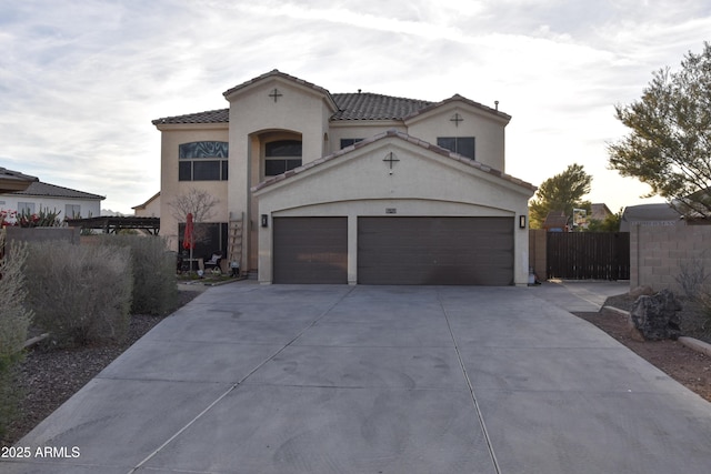 mediterranean / spanish-style home with a garage