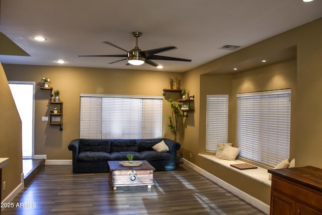 living room featuring dark hardwood / wood-style floors and ceiling fan