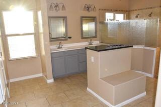 bathroom featuring a shower, tile patterned flooring, and vanity