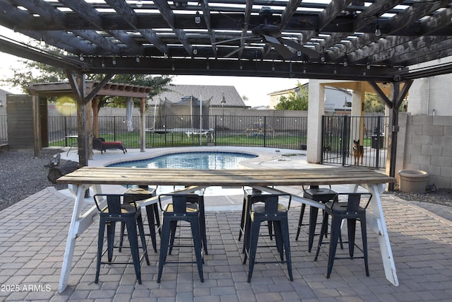 view of pool featuring a pergola, a patio area, and a trampoline