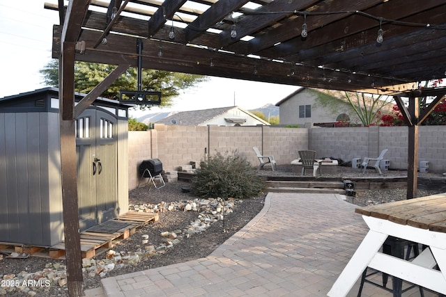 view of patio featuring a pergola and a storage shed