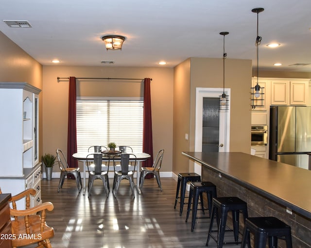 dining space featuring dark hardwood / wood-style flooring