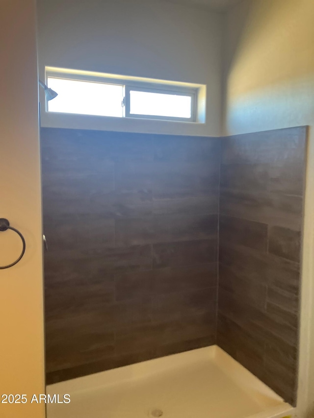 bathroom with a tile shower