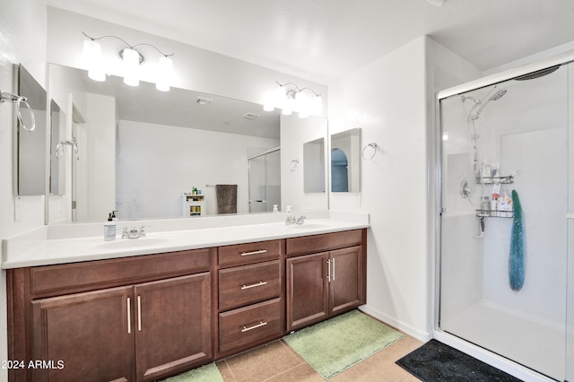 bathroom featuring vanity, tile patterned floors, and a shower with door