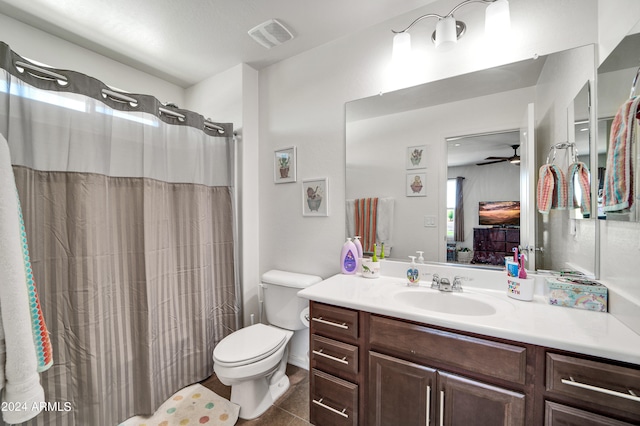 bathroom with a shower with shower curtain, vanity, toilet, tile patterned floors, and ceiling fan