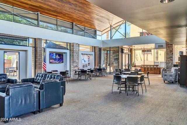 dining area featuring wood ceiling, high vaulted ceiling, and carpet