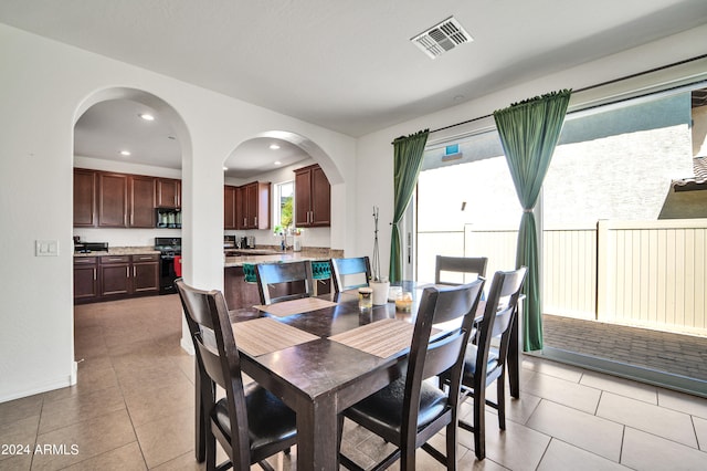 dining area featuring light tile patterned flooring