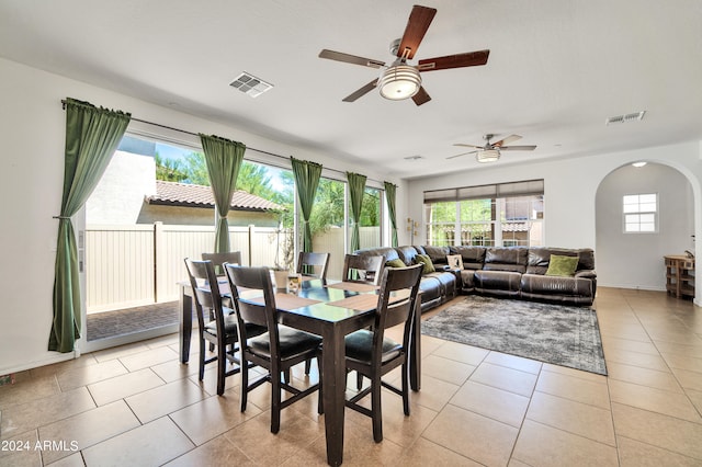 tiled dining space featuring ceiling fan