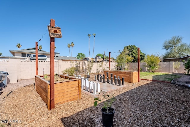 view of yard featuring a vegetable garden and a fenced backyard