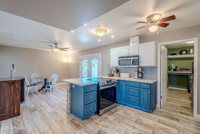 kitchen featuring light countertops, french doors, stainless steel appliances, white cabinetry, and blue cabinets