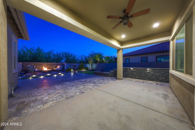 patio at twilight featuring ceiling fan