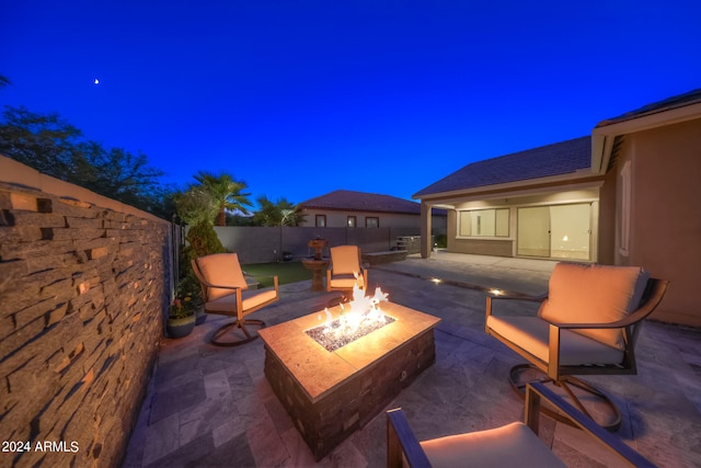 patio at night with an outdoor fire pit