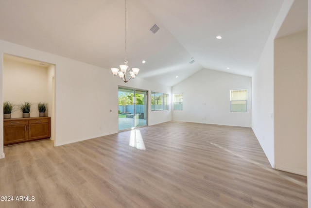 unfurnished living room with light wood-type flooring, lofted ceiling, and a notable chandelier