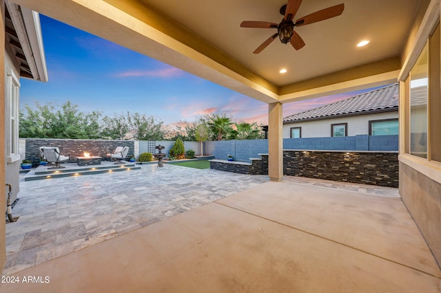 patio terrace at dusk featuring ceiling fan