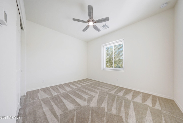 unfurnished room with light colored carpet and ceiling fan