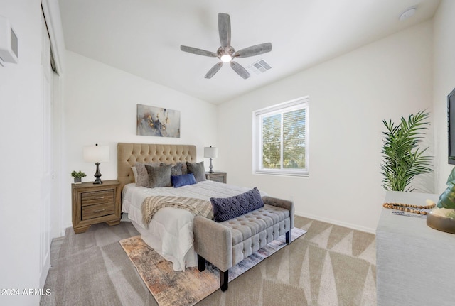 carpeted bedroom featuring ceiling fan and vaulted ceiling