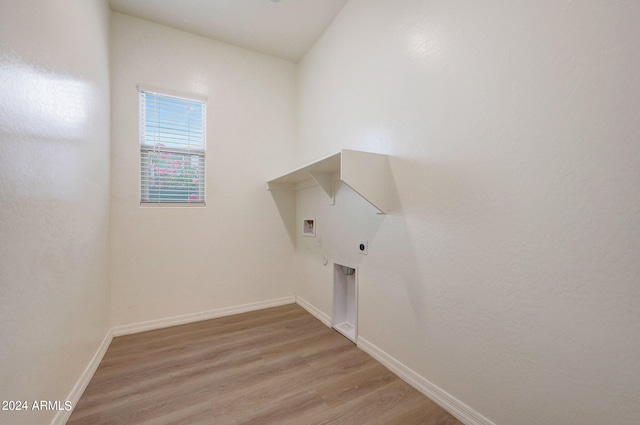 clothes washing area featuring hookup for a washing machine, hookup for an electric dryer, and light hardwood / wood-style flooring