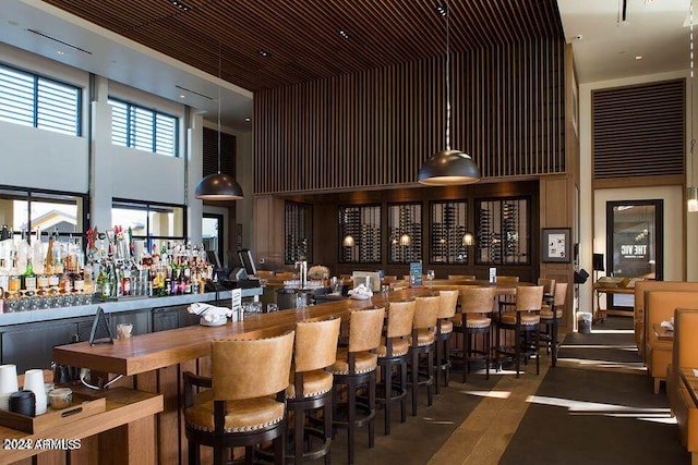 dining space with bar area and a high ceiling