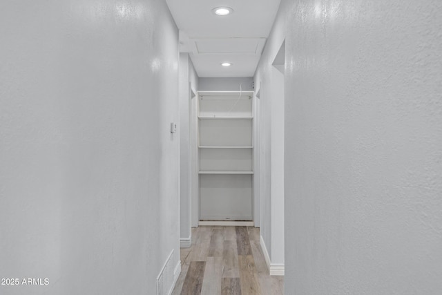 corridor featuring light hardwood / wood-style floors