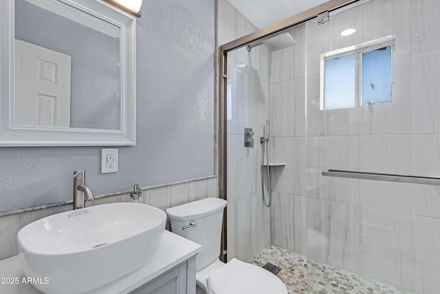 bathroom with vanity, toilet, and a shower with shower door