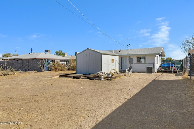 rear view of property featuring central AC