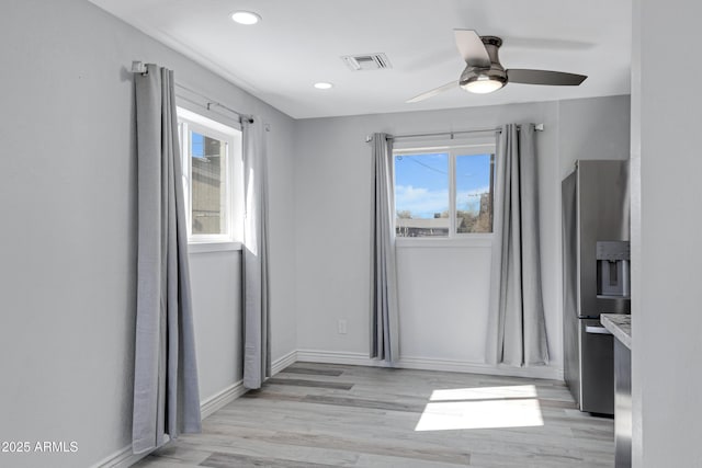 interior space featuring ceiling fan and light wood-type flooring