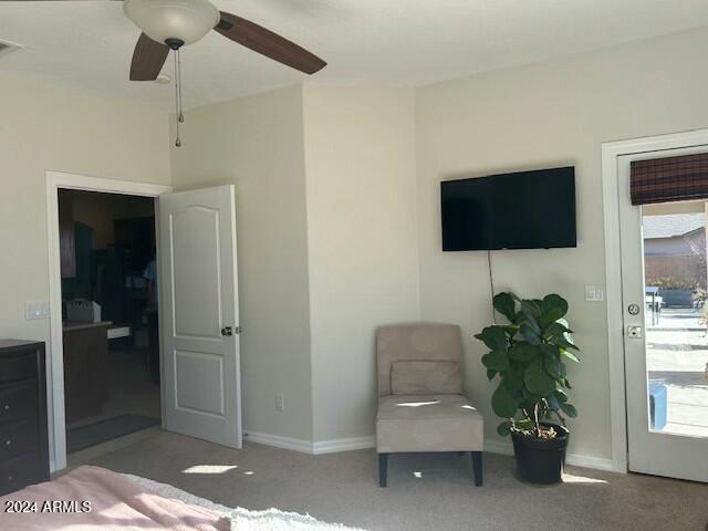 bedroom featuring light colored carpet and ceiling fan