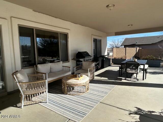 view of patio with grilling area and an outdoor living space