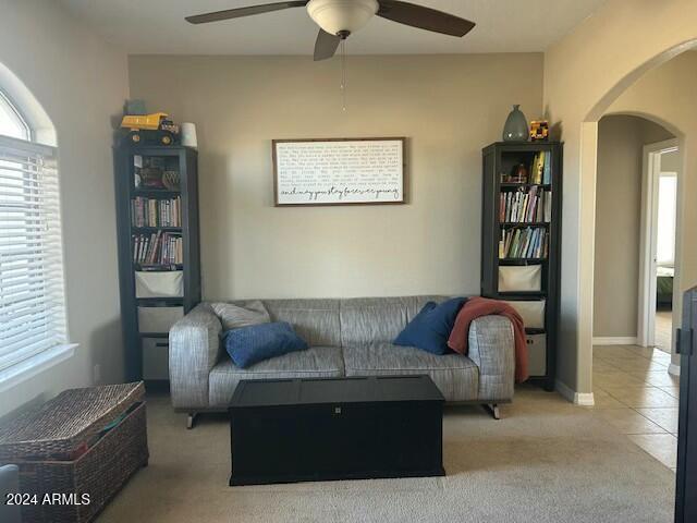 living room with ceiling fan and light carpet