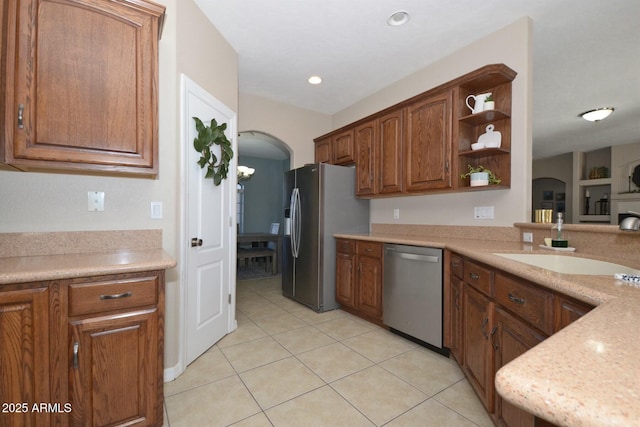 kitchen with light tile patterned floors, stainless steel appliances, and sink