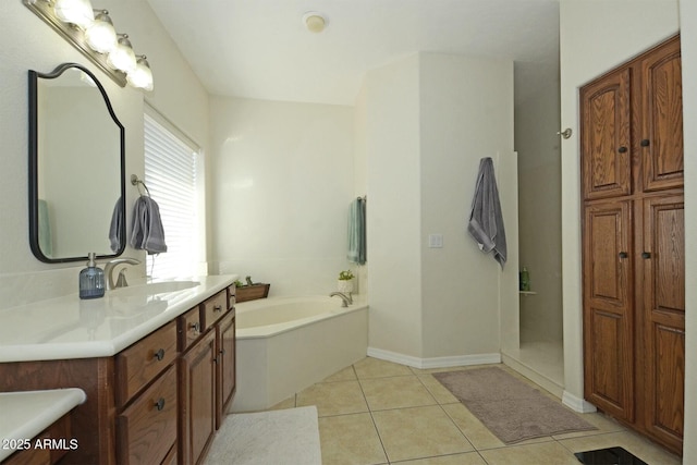 bathroom with tile patterned flooring, vanity, and a bathtub