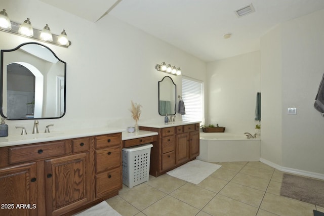 bathroom with vanity, tile patterned floors, and a bathing tub