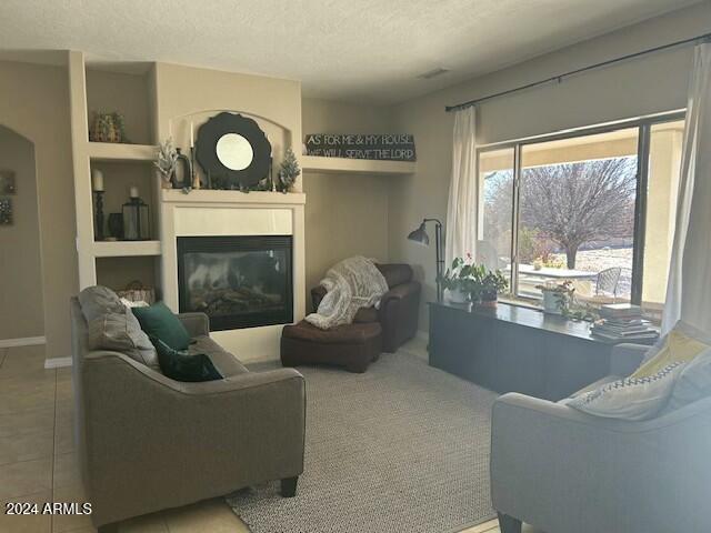 tiled living room with a textured ceiling