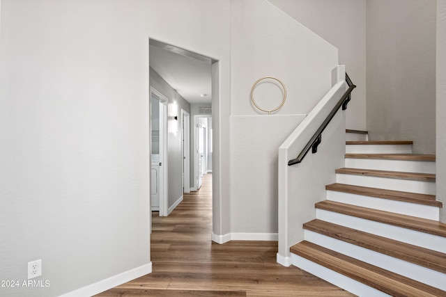 staircase with wood-type flooring