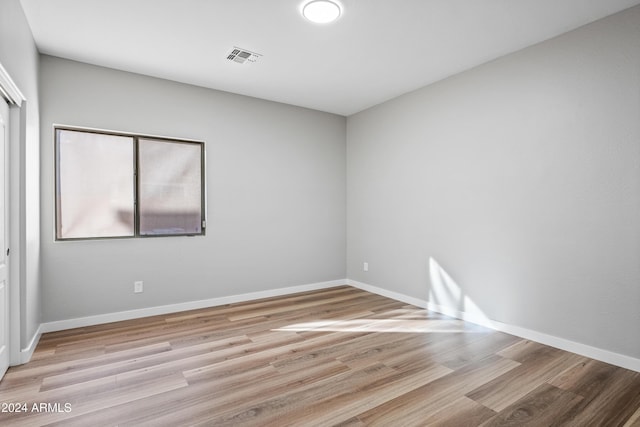 spare room featuring light hardwood / wood-style floors