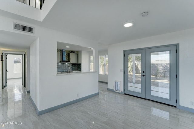 interior space featuring a wealth of natural light, french doors, and sink