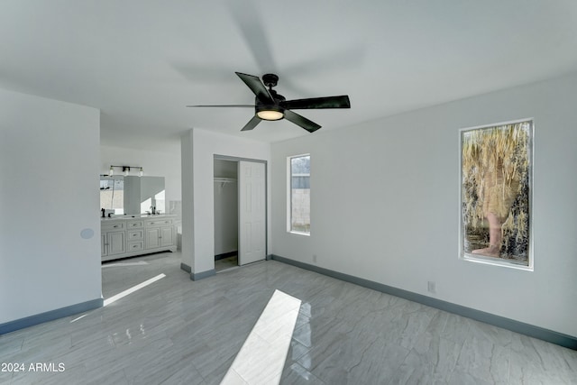 unfurnished bedroom featuring ceiling fan and a closet