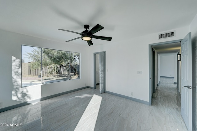 unfurnished room featuring ceiling fan