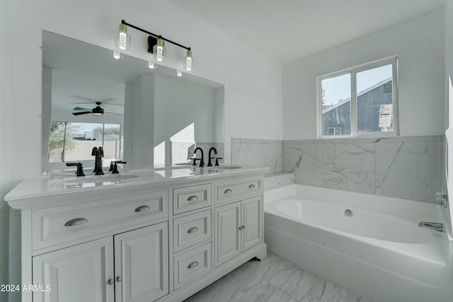 bathroom featuring a tub, ceiling fan, plenty of natural light, and vanity