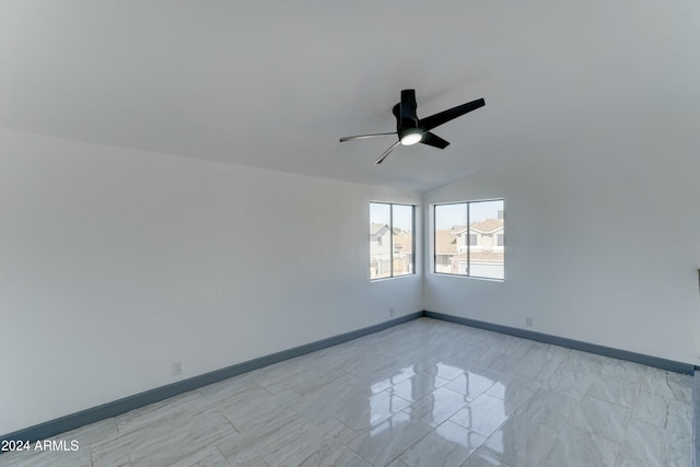 unfurnished room featuring ceiling fan and vaulted ceiling