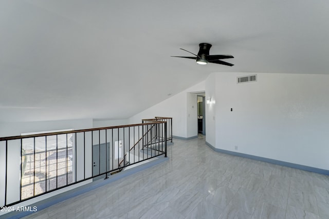 empty room with ceiling fan and lofted ceiling