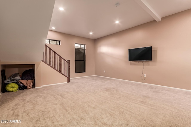 unfurnished living room with beam ceiling, recessed lighting, baseboards, and carpet floors