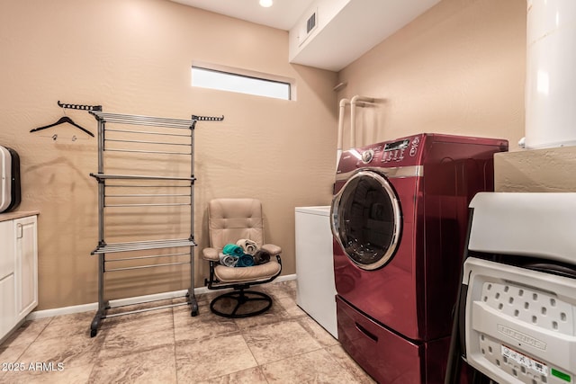 washroom featuring cabinet space, visible vents, and washer and dryer