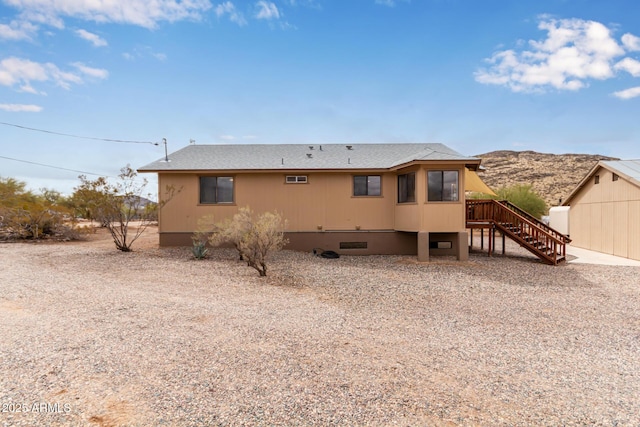 rear view of property with stairs, a mountain view, a shingled roof, and crawl space